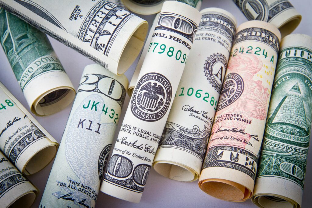 pexels-photo-164527-164527 Close-up of rolled US dollar bills symbolizing wealth, financial success, and currency.