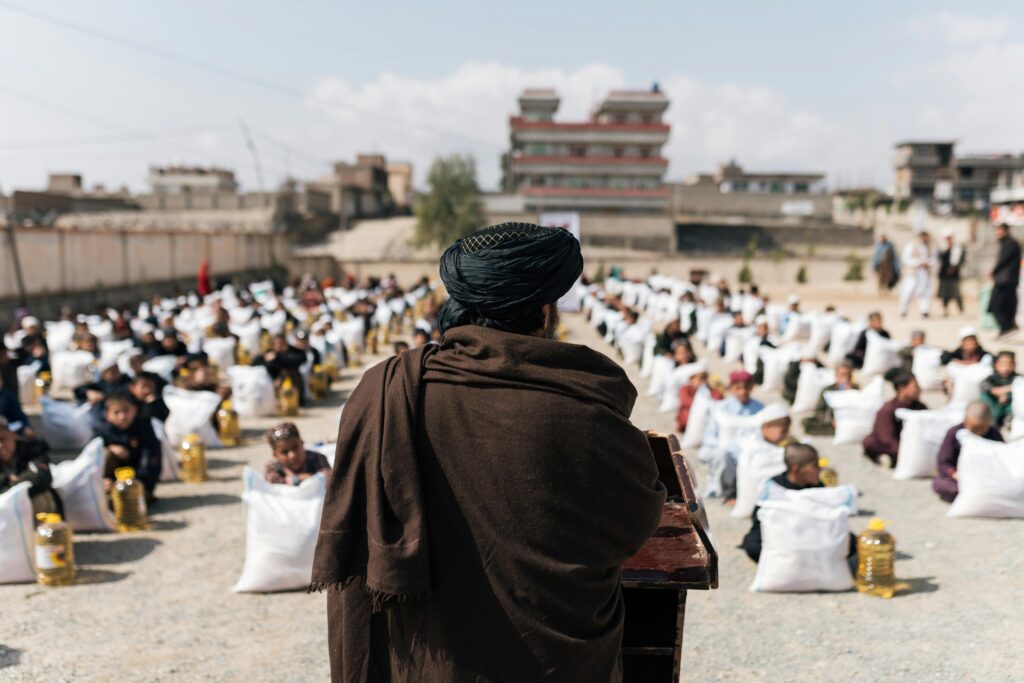 pexels-photo-31093762-31093762 Crowd gathered for a humanitarian aid distribution event in Afghanistan.