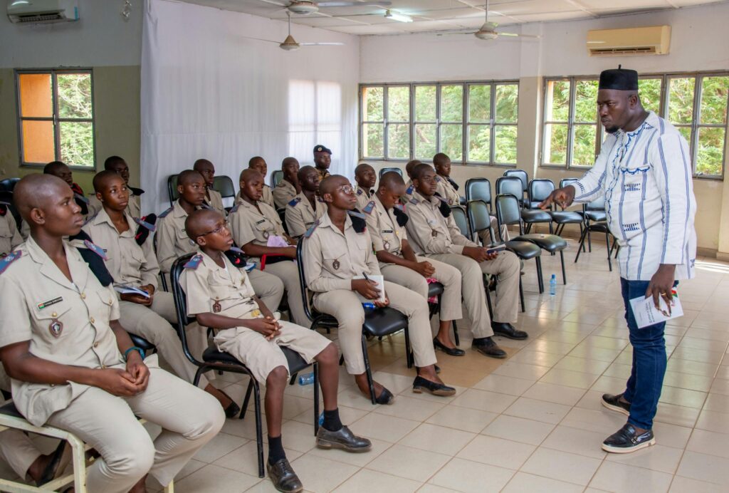 pexels-photo-31820970-31820970 A teacher engages with uniformed students in a classroom discussion, highlighting education and learning.