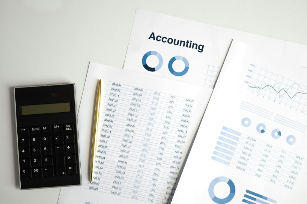 pexels-photo-6779714-6779714 Calculator and accounting documents with charts on a workspace.