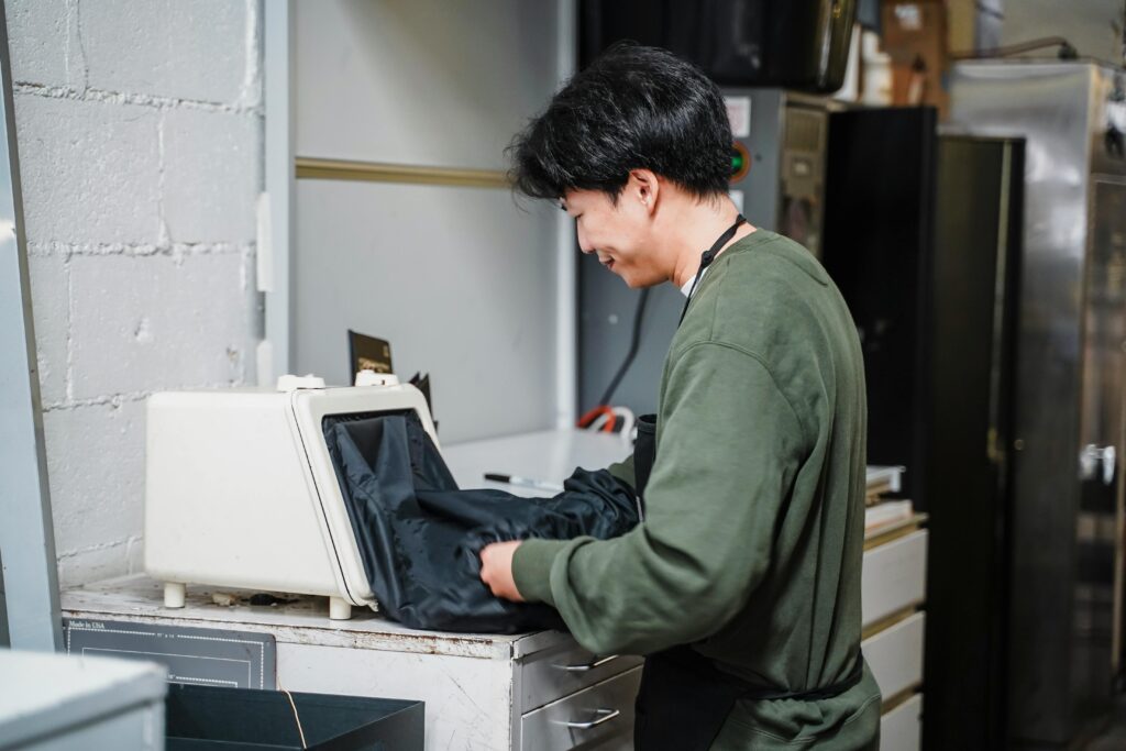 A man in a lab setting working with specialized equipment, focused on his task.