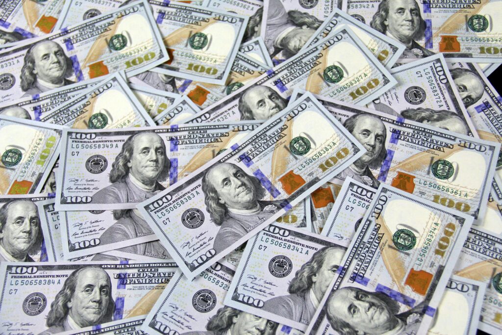 pexels-photo-3483098-3483098 Pile of US hundred dollar bills depicting financial success and wealth.