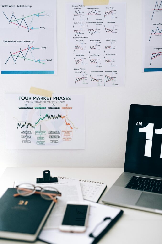 A desk with financial charts, a laptop, and office supplies, perfect for business analysis visuals.