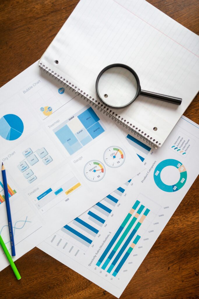 pexels-photo-7948058-7948058-1 A set of financial charts and graphs with a magnifying glass, perfect for business reports.